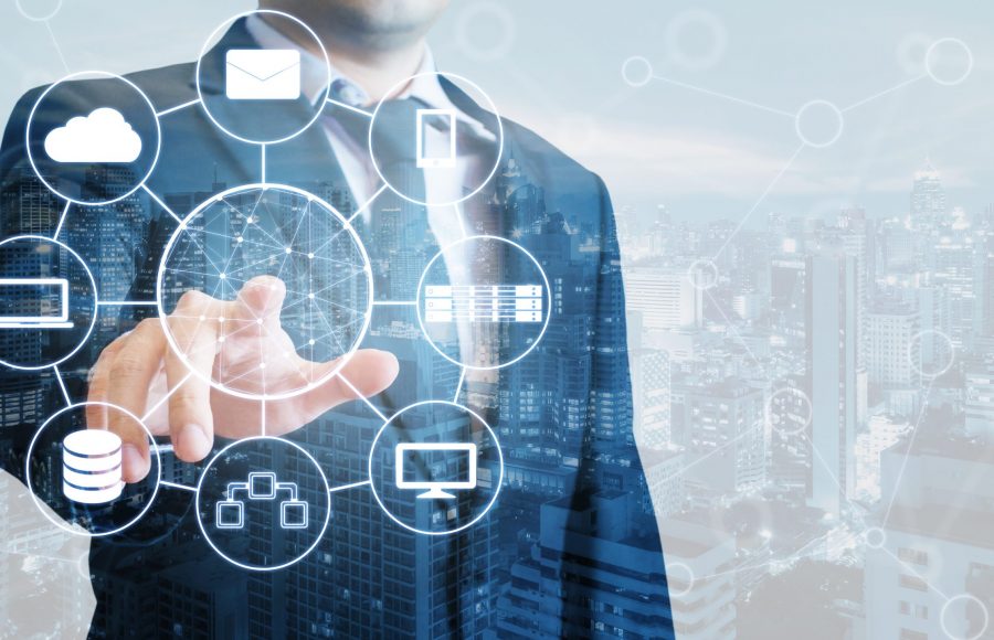 Double exposure of professional businessman connected devices wi Double exposure of professional businessman connected devices with world digital technology internet and wireless network on touch screen and city of business background in business and technology concept